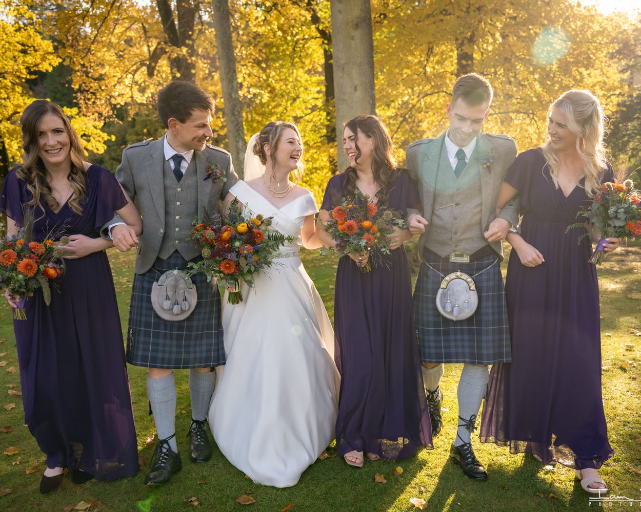 A group of guests celebrating a couple with confetti