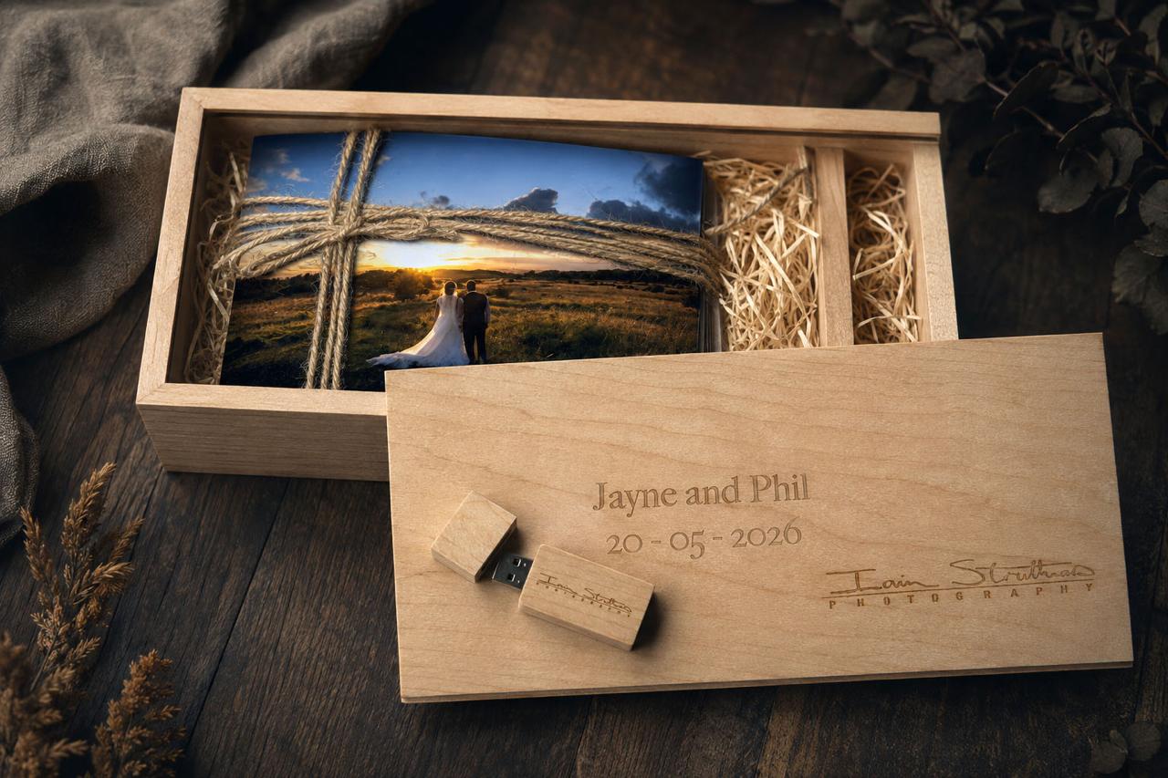 Personalised wooden presentation box engraved with the couple's names and wedding date, with USB and prints